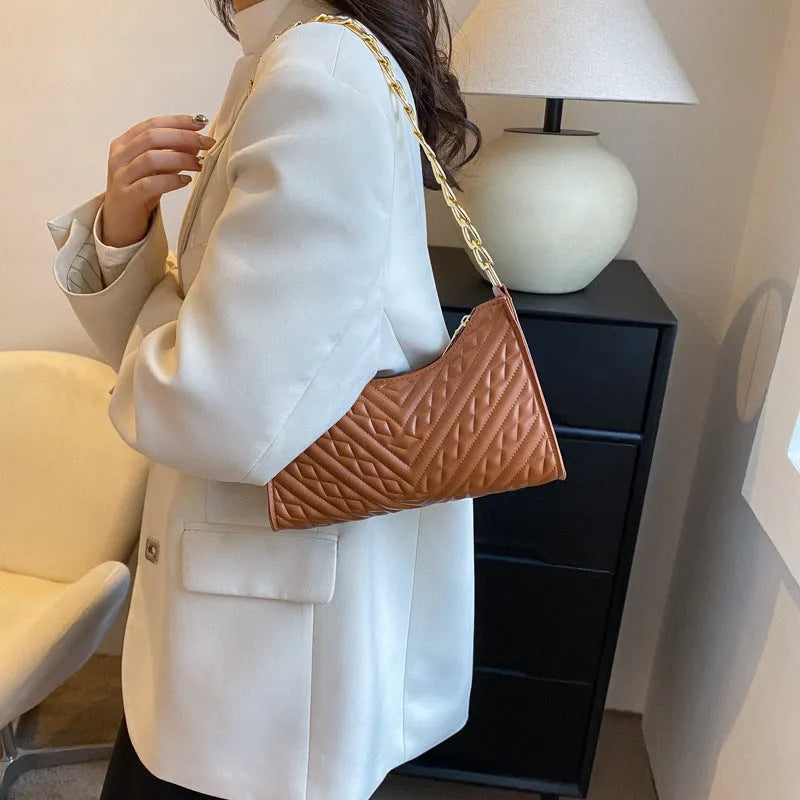 Pleated chain strap baguette shoulder bag in vertical square shape with soft PU leather exterior