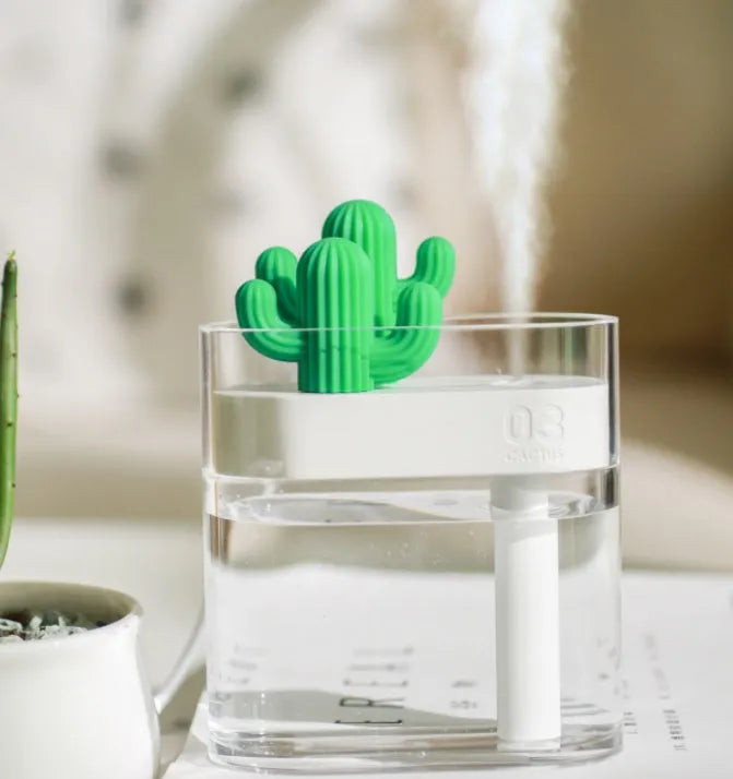 Transparent green cactus USB portable humidifier on desk showing water level inside plastic body