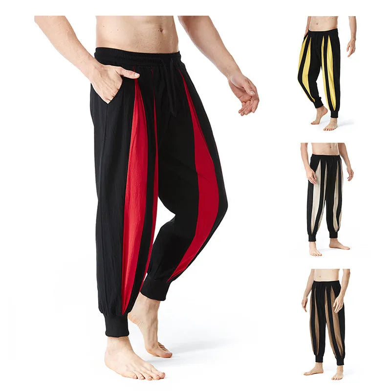 Man wearing straight-leg casual trousers in one of four available colours: brown, khaki, red, or yellow.