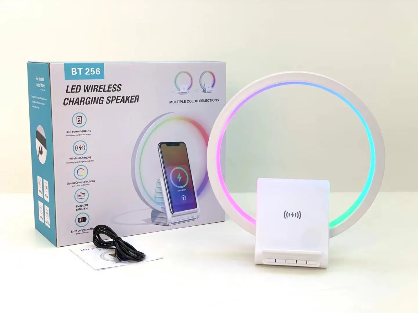 White smart Bluetooth speaker with built-in ambient light and 15W wireless charging pad on top.