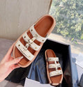 Women's Roman style sandal slippers in patent leather finish with sheepskin upper