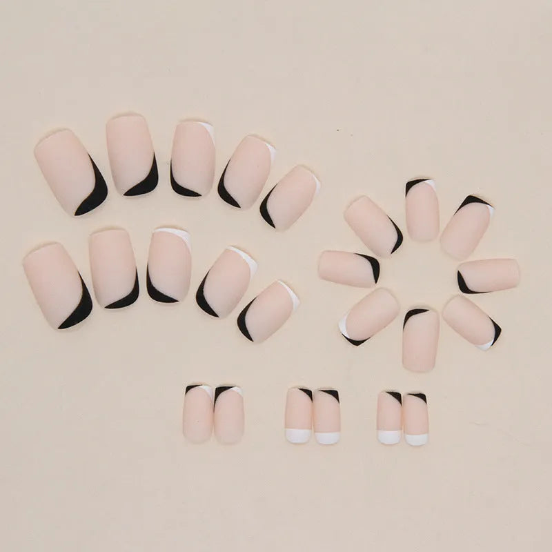 Black and white frosted gel manicure set with plastic nail armour pieces.