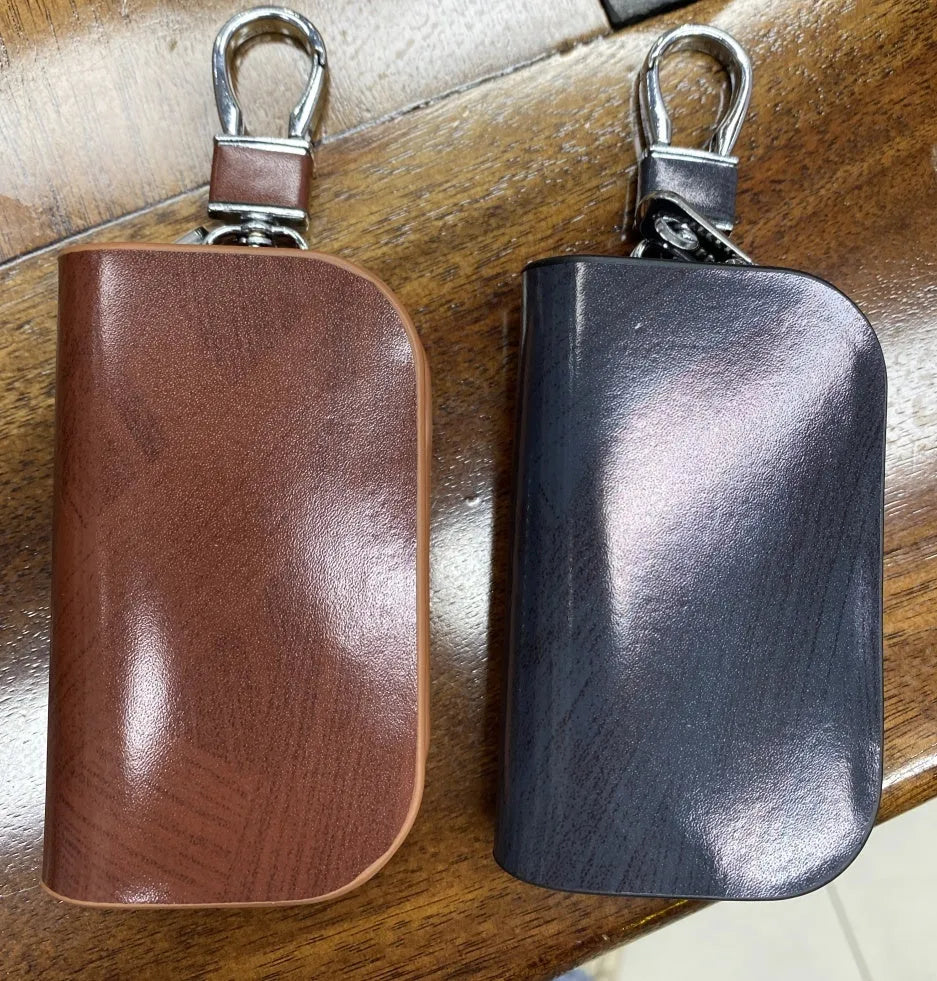 Genuine leather car key case with zipper in black and brown.