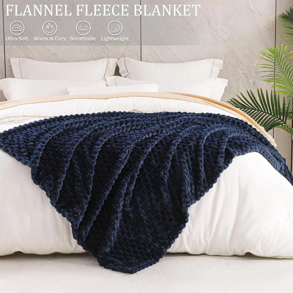 Children's soft polyester plaid blanket in camel colour, folded on a bed
