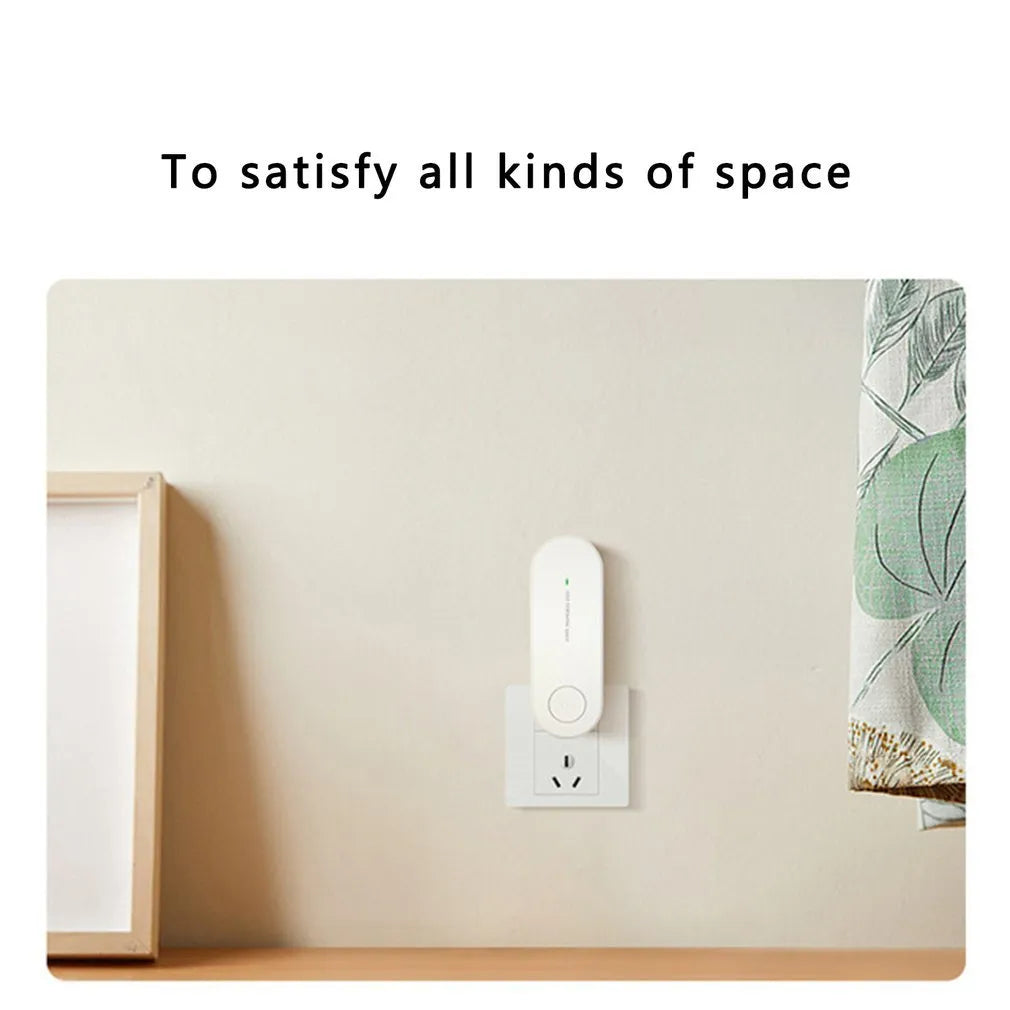Small negative ion air purifier in black, plugged into a wall socket, with a room in the background