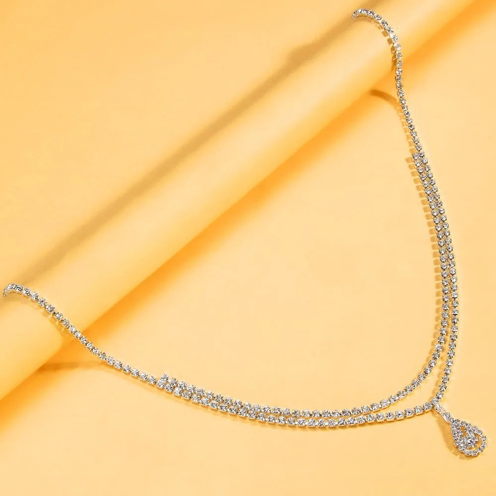 Gold women's waist chain with water drop rhinestone pendant and lobster buckle closure