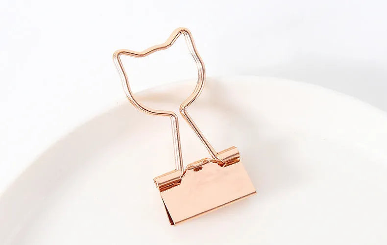 Golden decorative alligator clip with choice of flamingo, love, clouds, cat, cactus, or bow motif designs