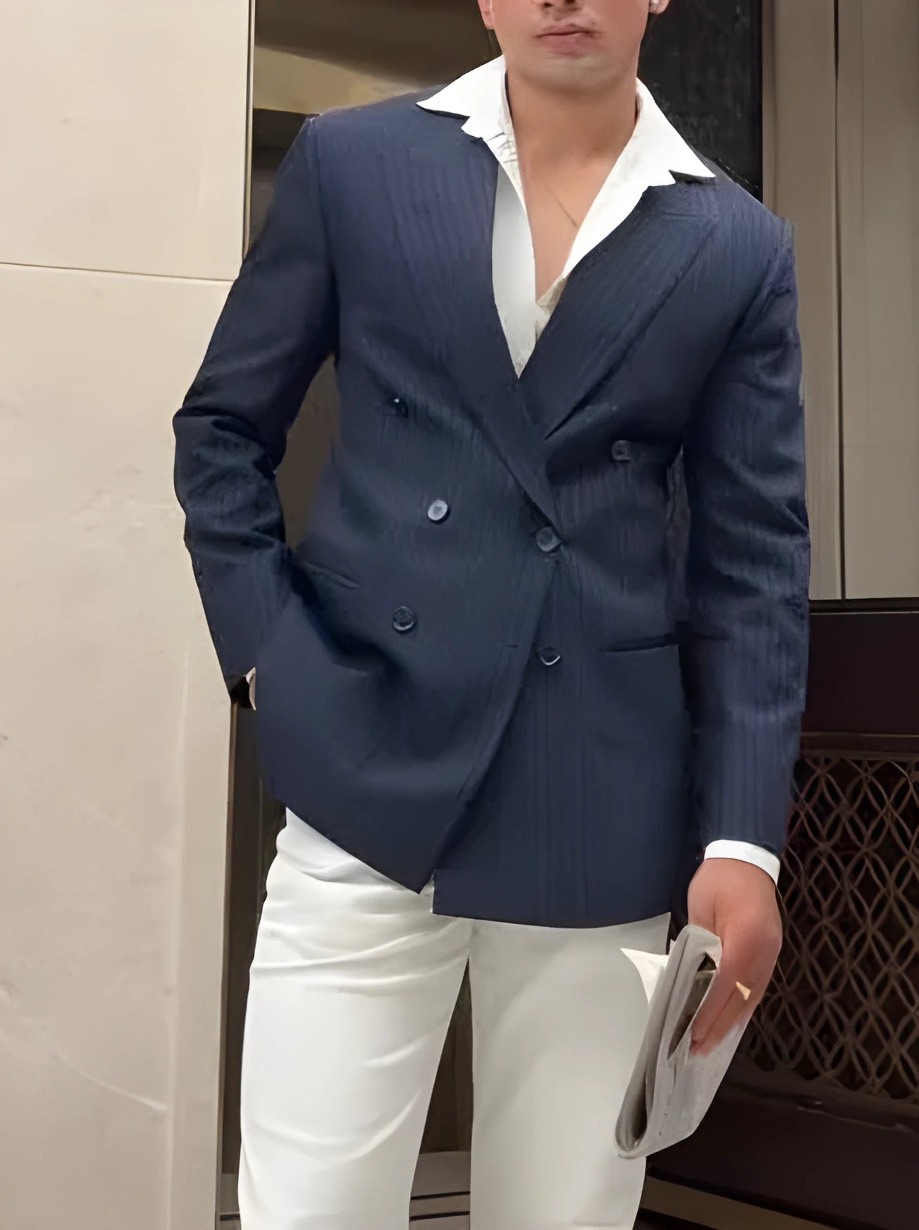 Man wearing a classic striped double-breasted polyester blazer jacket.