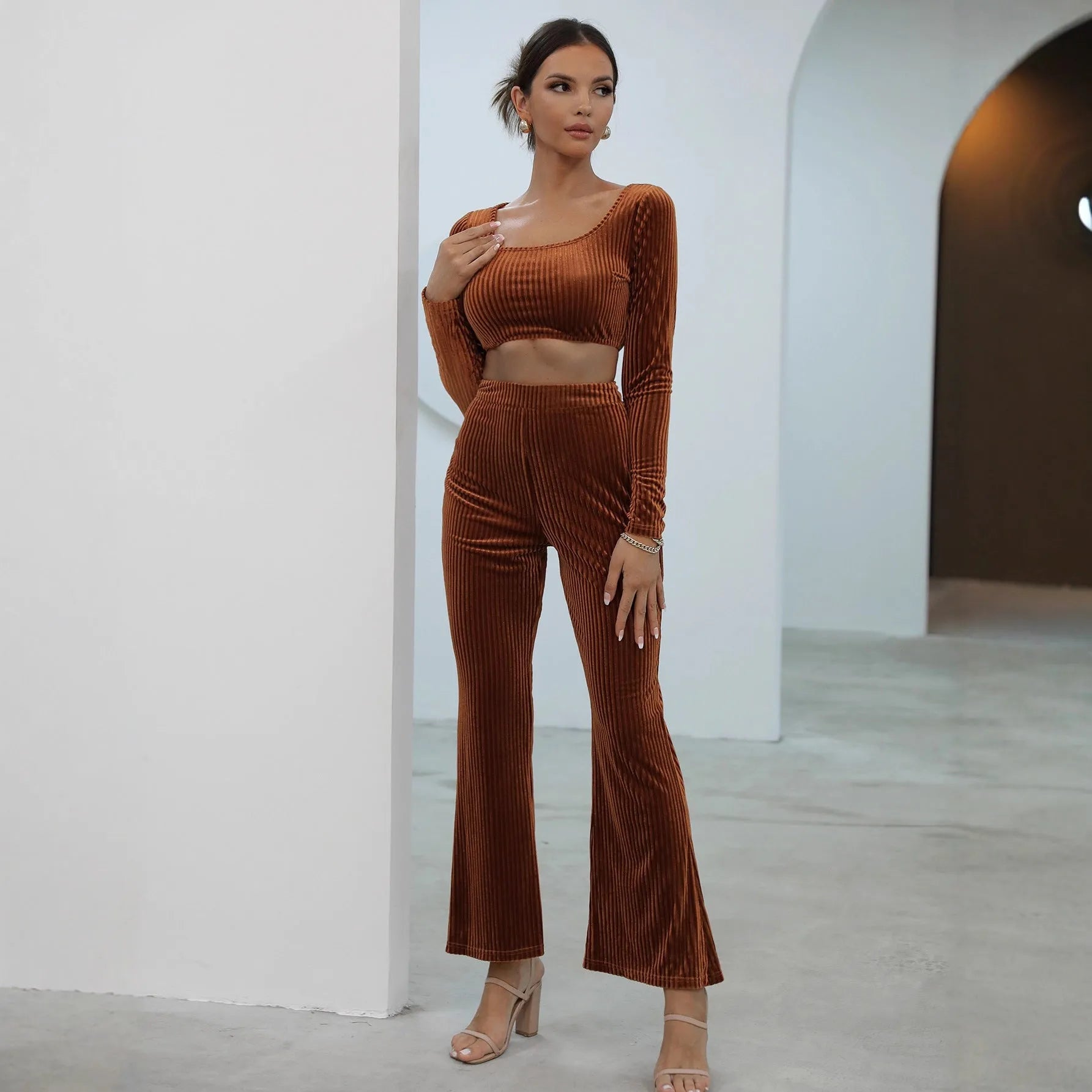 Caramel coloured long sleeve sweater and matching trousers loungewear set on a hanger