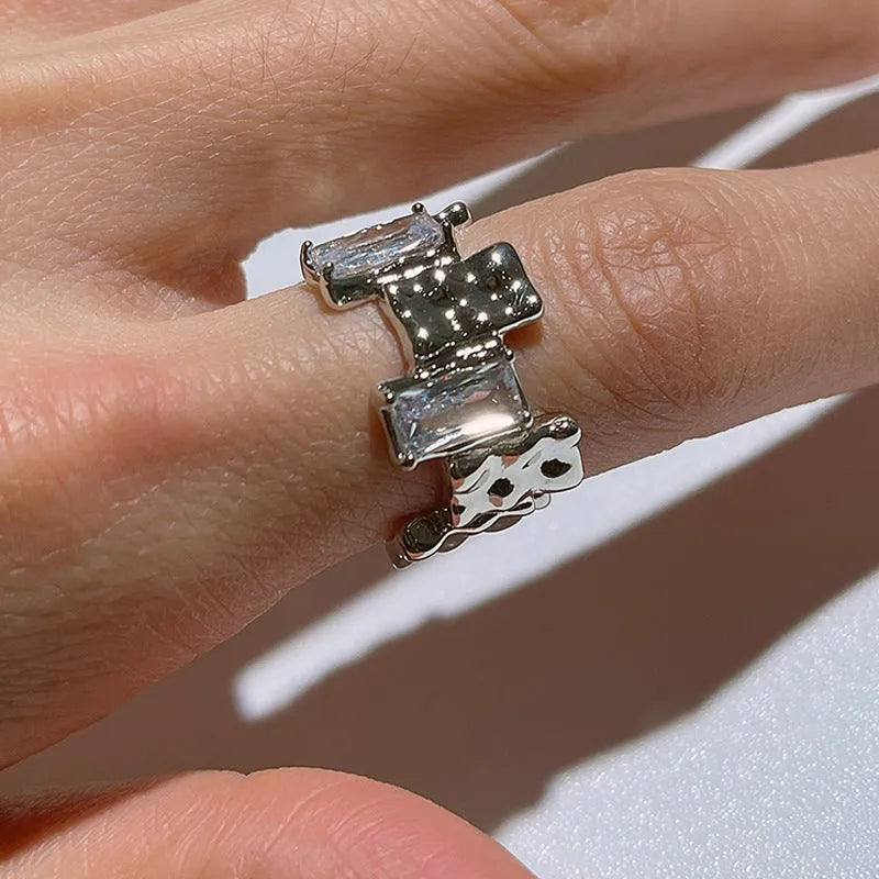 Silver geometric cross ring with open zircon stone setting and retro design