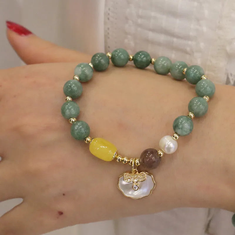 Natural green jade shell bracelet on display showing shell-shaped stone pieces in pictured colour