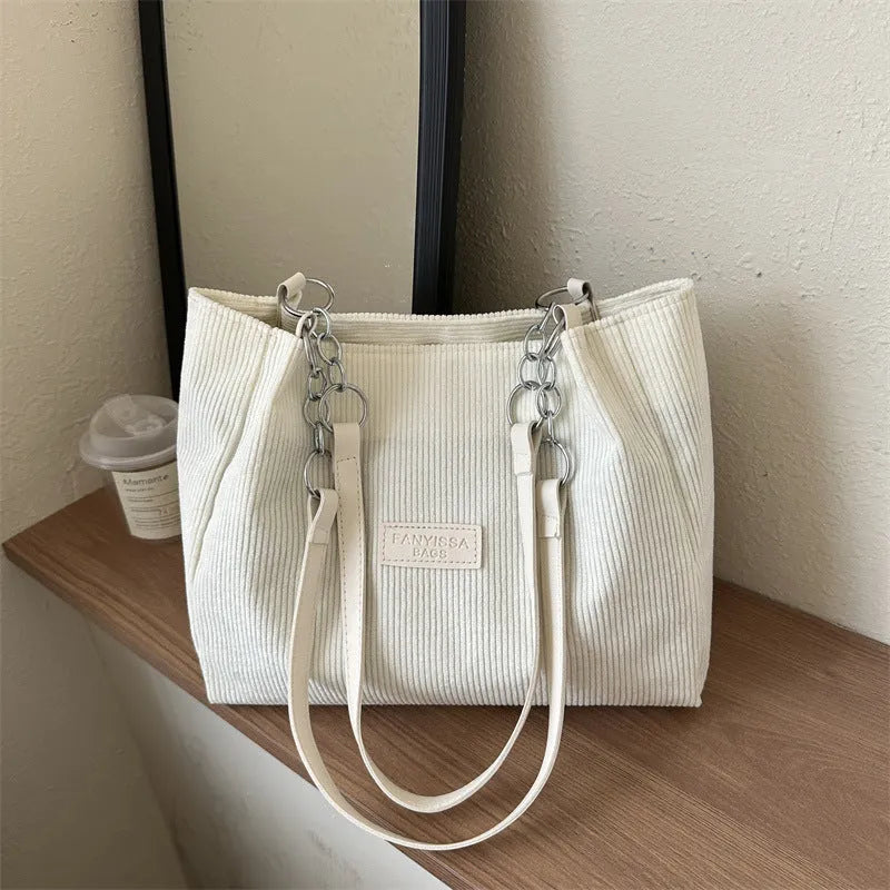 Corduroy one-shoulder large capacity tote handbag for women in black, brown, and white with outer pocket