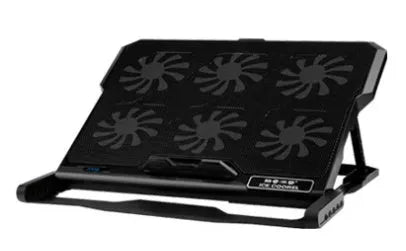 Black metal mesh laptop cooling board with USB cable on a desk next to a notebook.