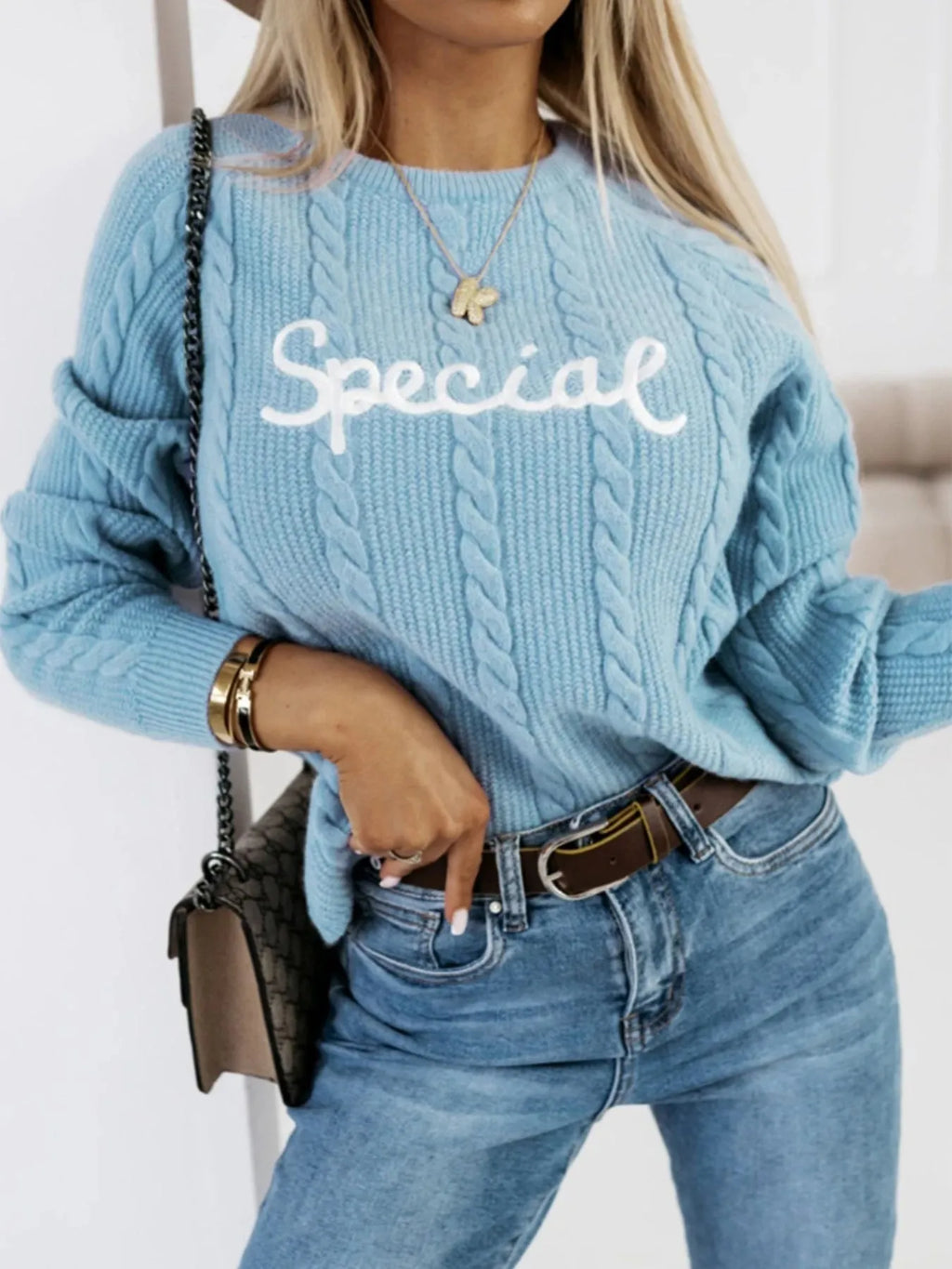 Blue pullover sweater with embroidered letters and numbers pattern on crew neck knitwear