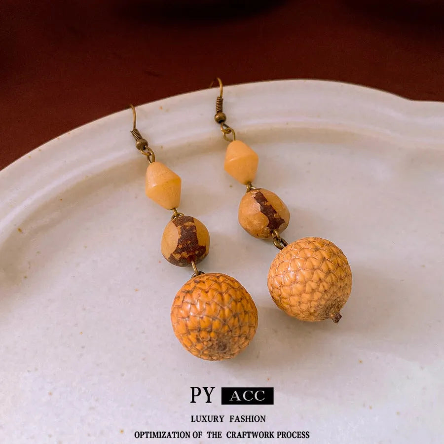 Retro ethnic style brown resin fruit core tassel earrings with geometric round design for women.