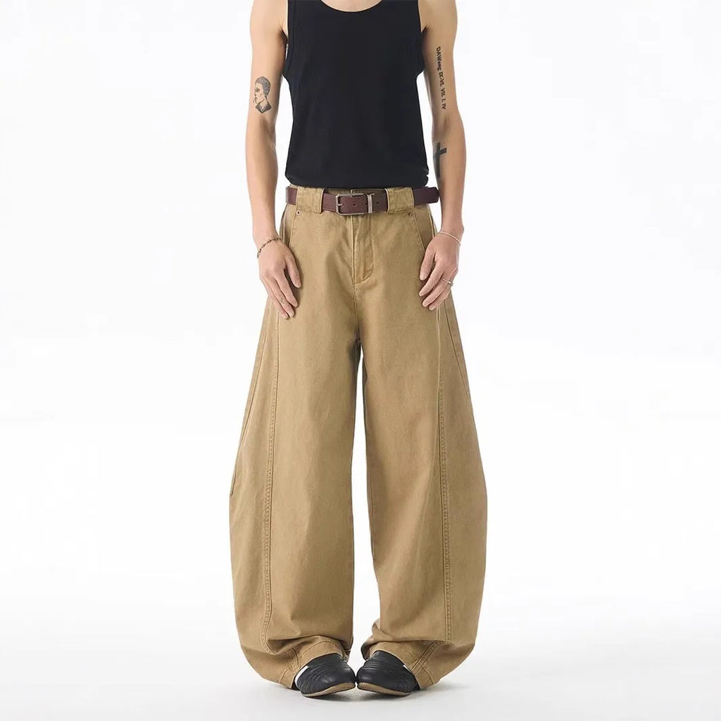 Brown men's loose-fit straight leg denim jeans with a button fly on a neutral background.