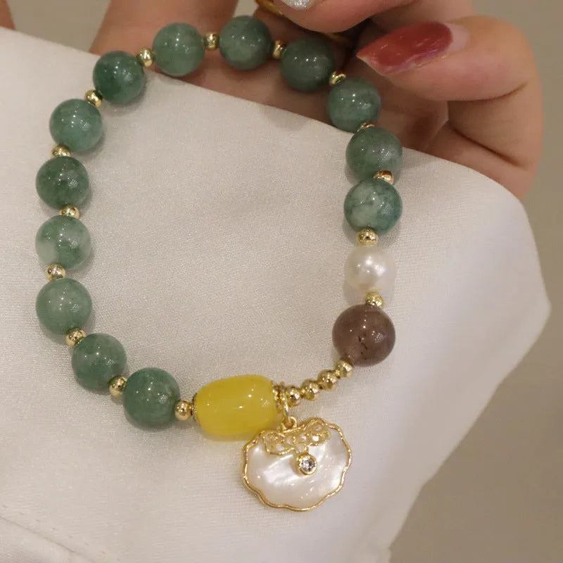 Natural green jade shell bracelet on display showing shell-shaped stone pieces in pictured colour
