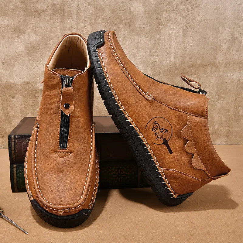 Men's black slip-on leather loafers with a round toe and flat rubber sole, shown on a foot.