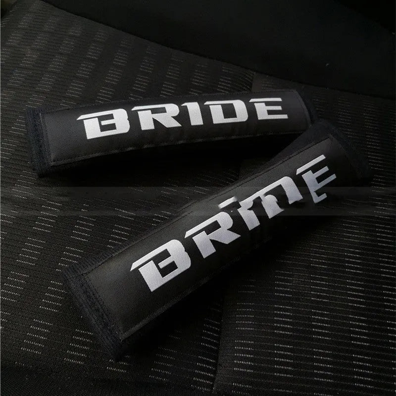 Black car seatbelt shoulder pad made of sponge cloth and cotton, showing embroidery weave detail.