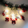 Christmas LED string lights with warm white glow showing snowman and elk deer themed lamps on a dark background