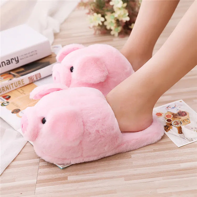 Pink pig floor slippers with plush lining shown on clean indoor surface