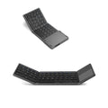 Black tri-fold Bluetooth keyboard shown open next to a tablet and folded in hand.