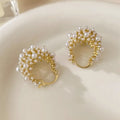 Gold-coloured copper flower basket earrings with white pearl inlay and small rice-shaped bead details.