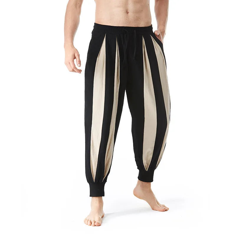 Man wearing straight-leg casual trousers in one of four available colours: brown, khaki, red, or yellow.