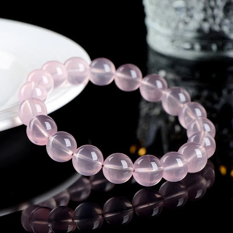 Natural starlight crystal women's bracelet with polished pink round beads in single circle design