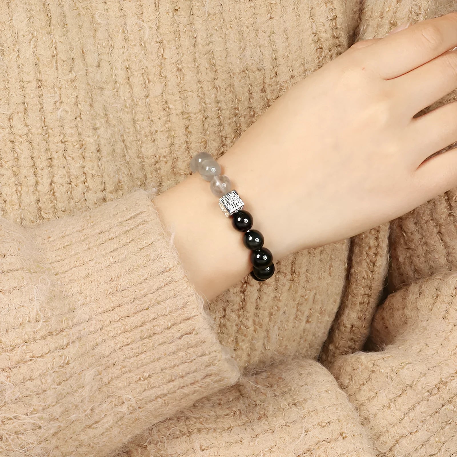 Polished crystal bracelet in khaki with 10mm geometric beads on a neutral background