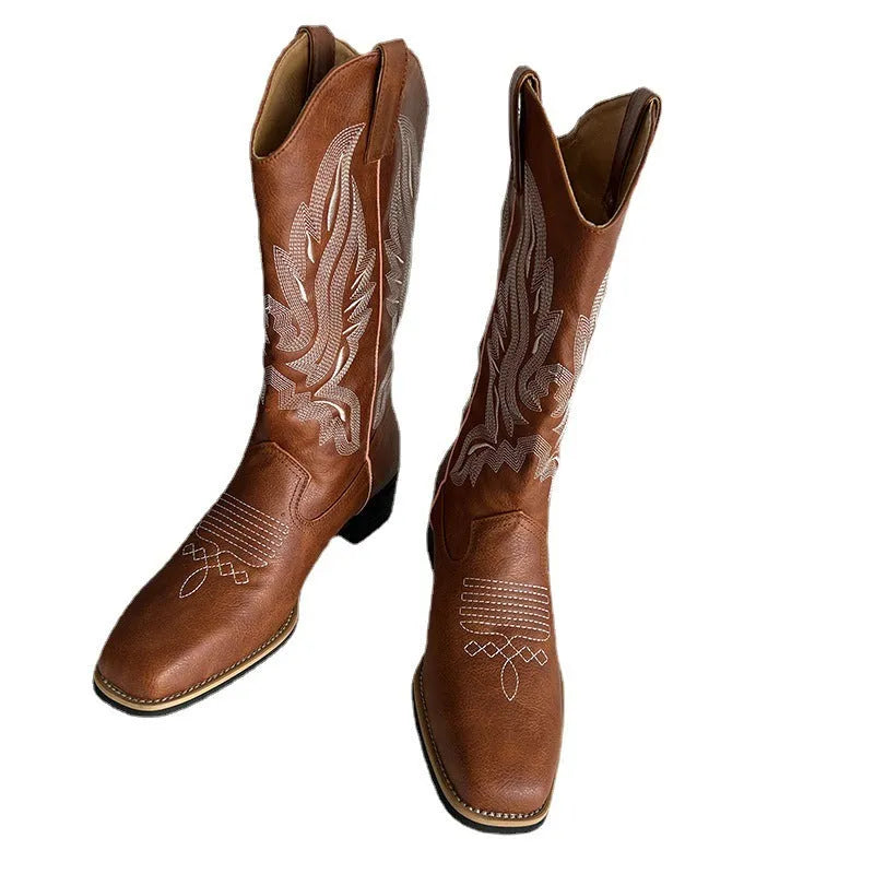 Brown women's mid-calf boots with embroidery detail on the shaft, shown from the side.
