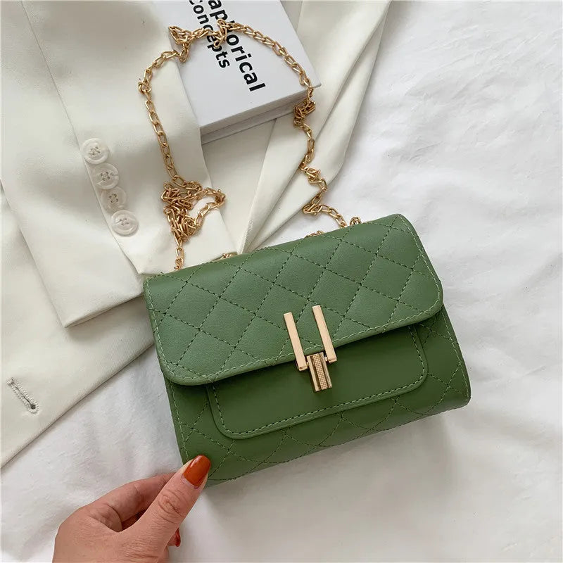 Women's diamond lattice chain crossbody bag in black, green or white with adjustable strap