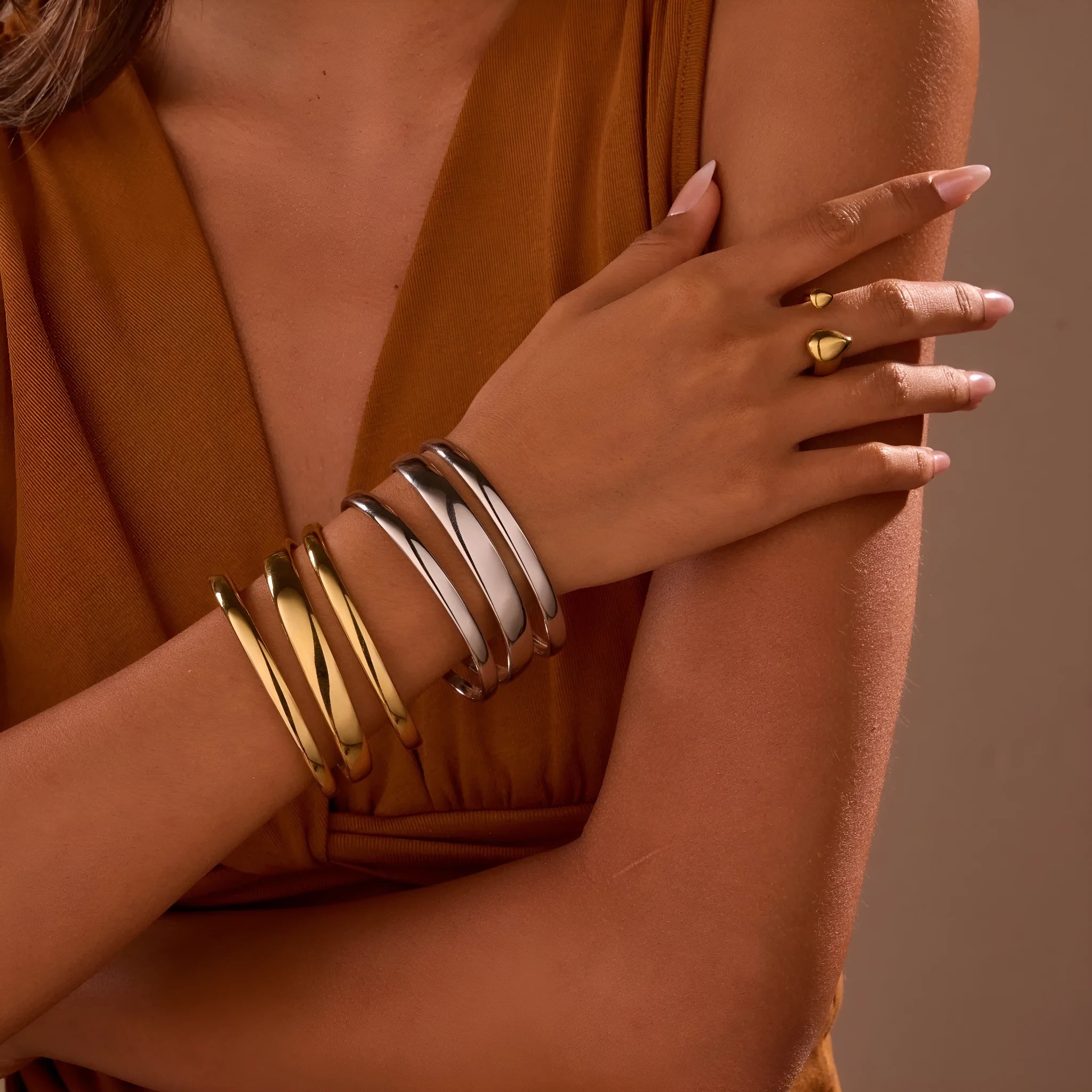A simple open geometric stainless steel bracelet for women, shown in a gold tone finish.