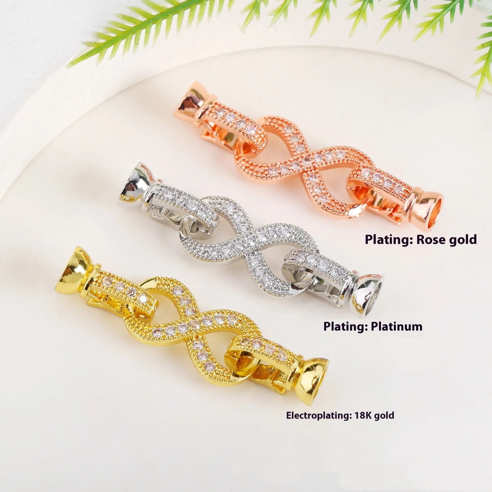 Small gold-coloured metal jewellery clasp on a white background.
