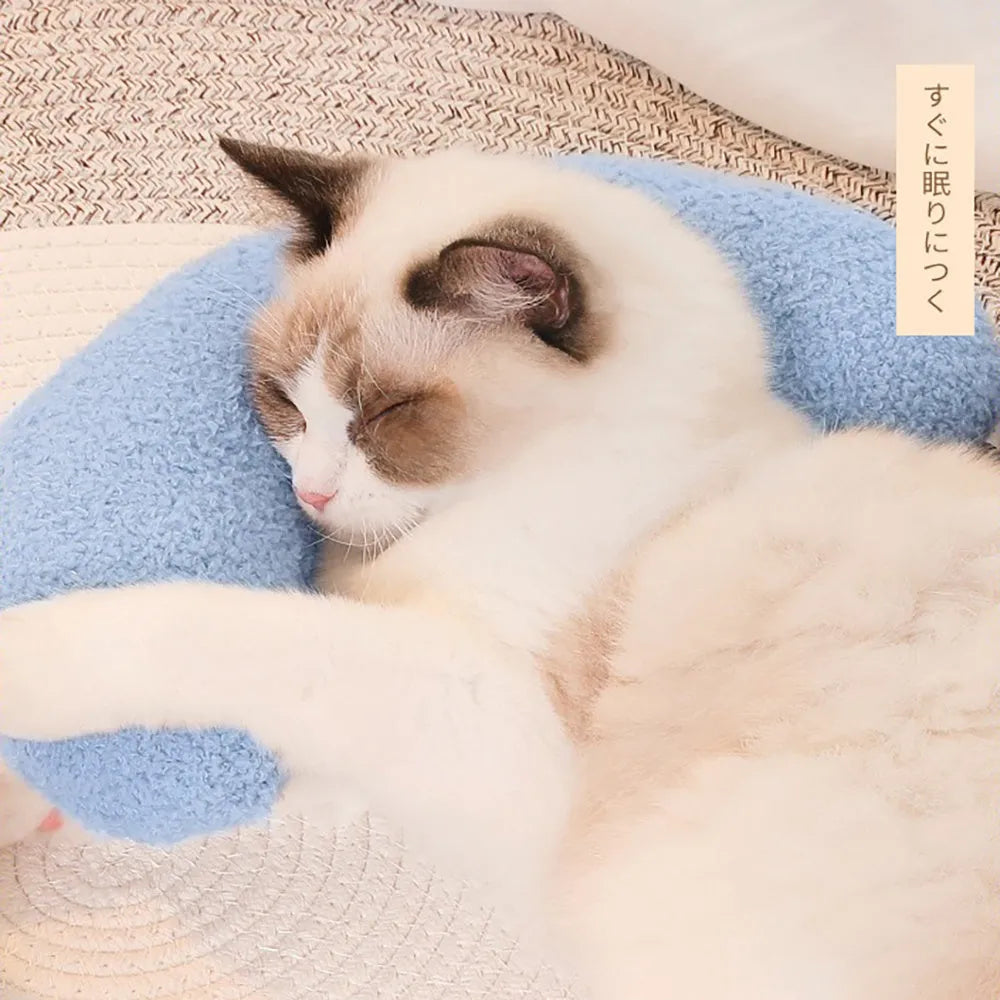 Blue U-shaped cat pillow with adjustable neck collar on sofa