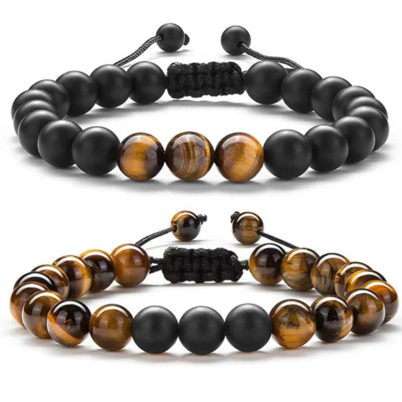 A pair of geometric bracelets with matte black tiger eye agate beads on an adjustable strap.