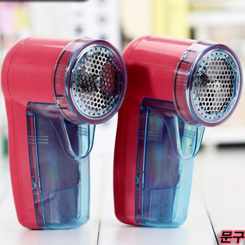 Portable electric clothing lint remover showing compact white body and shaving head