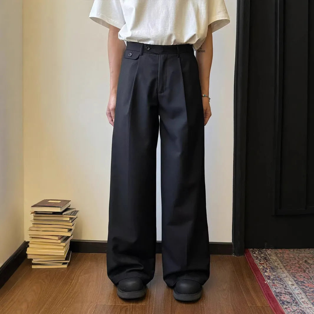 Men's brown straight-leg casual suit trousers with a loose, wide-leg fit on a hanger.
