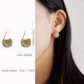 Gold and white geometric drop earrings with sphere elements and crystal embellishments