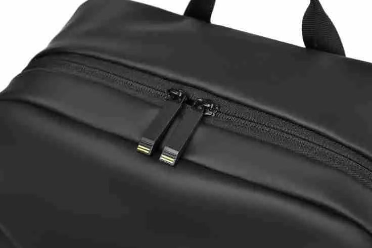 Large simple design waterproof backpack in grey with visible stitching, shown with a separate computer bag.