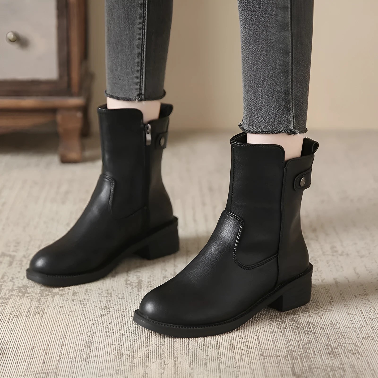 Black women's low heel ankle boots with side zip fastening and round toe design