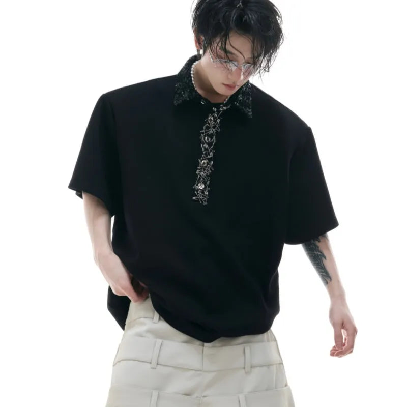 Loose fit black men's polo shirt with square collar, short sleeves, and embroidered sequin detailing.