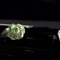 Solid gypsum car air vent perfume diffuser in off-white or green with 5ml jasmine oil bottle.