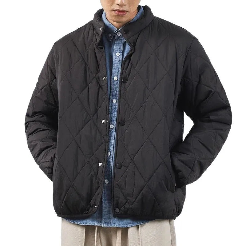 Men's black elongated winter jacket with diamond quilted pattern on a mannequin.