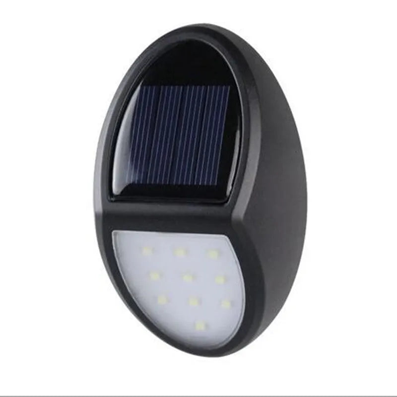 Black rectangular LED solar wall light for outdoor mounting with a solar panel on top.