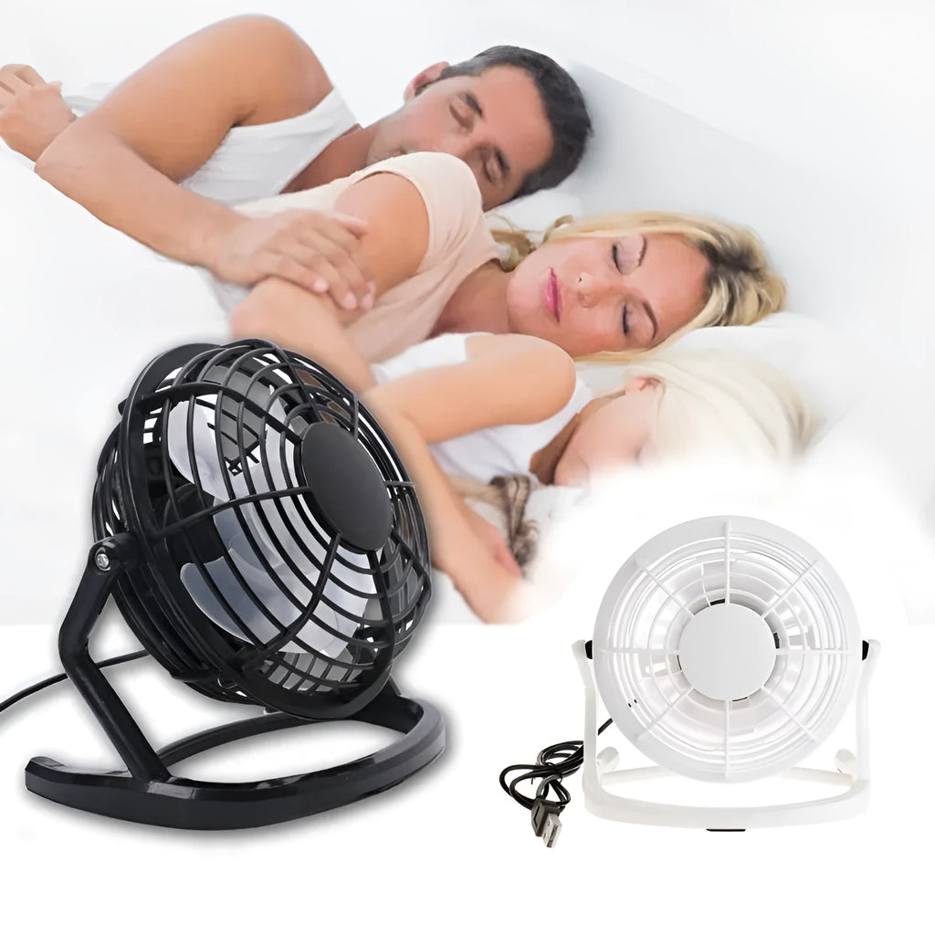 Mini adjustable USB desk fan in black on a desk next to a laptop