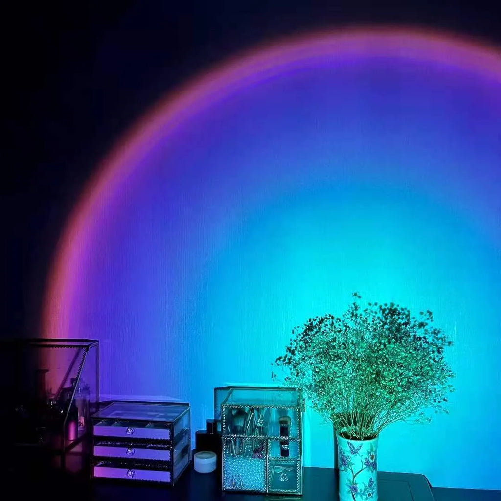 Rechargeable sunset projection lamp with USB cable showing rainbow and red light effect.