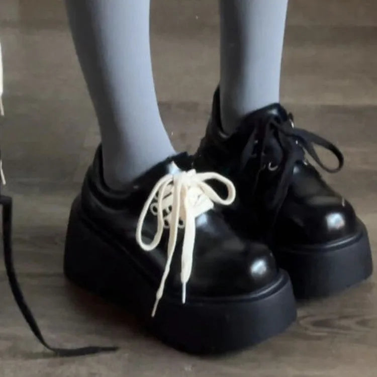 Women's matte black chunky heel lace-up shoes with a round toe and thick rubber sole.