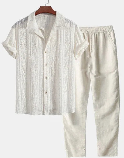 Man wearing a loose-fit short sleeve shirt and trousers from the milk silk polyester summer suit in a neutral colour.