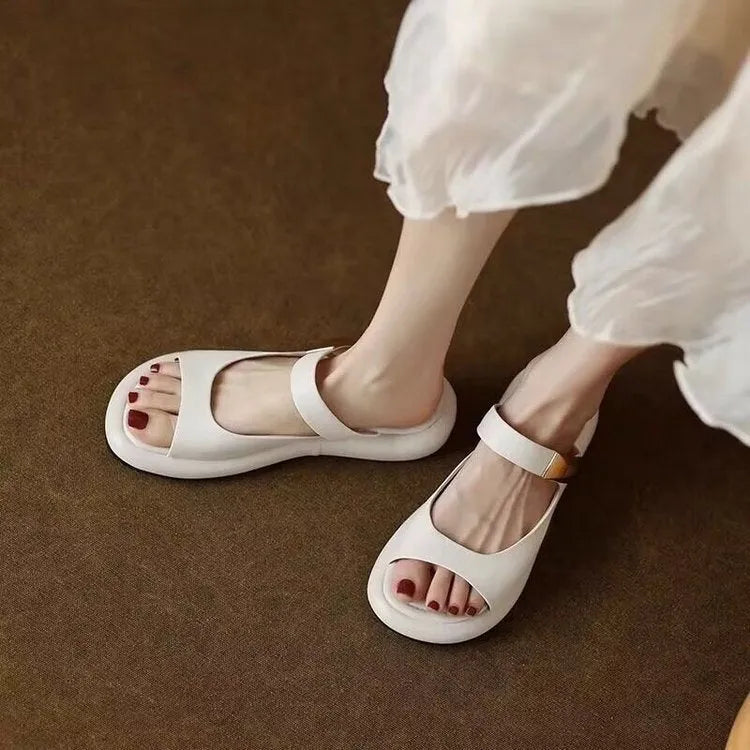 Apricot peep toe flat sandals with a platform sole and leather upper